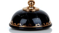 Elegant black ceramic cloche with copper accents isolated on white background for luxury dining presentation and gourmet food service applications.