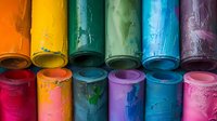 Colorful rows of paint cans with vibrant spilled paint drips, perfect for creative and artistic design projects, showing texture and artistic expression in rainbow colors.