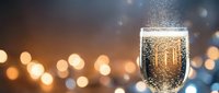 Sparkling champagne glass with golden bubbles against warm bokeh lights background for celebration and festive occasions.
