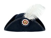 Black velvet tricorn hat with white feather plume and decorative gold-centered rosette brooch, isolated on white background for costume and theatrical design use.