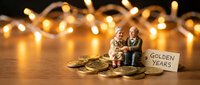 Elderly couple figurines sitting together surrounded by golden coins with warm fairy lights creating romantic bokeh background for retirement planning concepts.