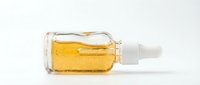 Golden serum in glass dropper bottle for skincare routine and beauty treatment on white background isolated for cosmetic design.