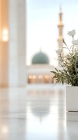 Soft focus view of mosque dome and minaret with white flowers in foreground vase, creating peaceful spiritual atmosphere with gentle bokeh lights.
