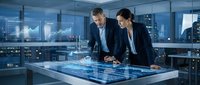 Professional business team analyzing data on interactive touchscreen table in modern corporate office with city skyline view at night.