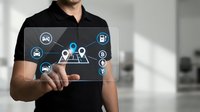 Professional businessman in black polo shirt interacting with digital interface displaying location and navigation icons for business applications.
