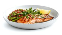 Grilled salmon fillet with asparagus, quinoa, fresh herbs, and lemon wedge served on white ceramic plate, healthy Mediterranean cuisine.