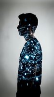 Male programmer silhouette with digital code overlay representing software development and technology innovation in modern computing industry.