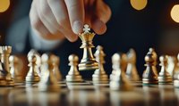 Hand moving golden king chess piece on wooden board with blurred bokeh background, demonstrating strategy and leadership in competitive game.
