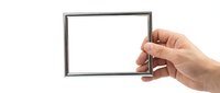Hand holding empty silver picture frame isolated on white background for mockup design and photo placement projects.