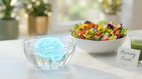 Glowing brain hologram in glass bowl on kitchen counter with fresh salad and morning focus note for cognitive health and mental wellness concepts.