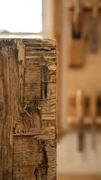 Weathered wooden beam showcasing natural grain patterns and rustic texture in warm interior setting for construction and design projects.