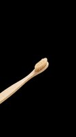 Wooden toothbrush with natural bristles isolated on transparent background, ready for dental care designs, t-shirt graphics, clipart, stickers, and print-on-demand products.