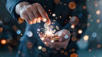 Male hands holding glowing coins with magical light particles, symbolizing financial growth, investment success, and digital currency transformation.