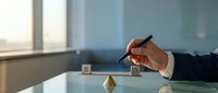 Professional businessman hand stamping document with wooden rubber stamp on glass desk in modern office environment for approval and certification processes.