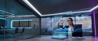 Futuristic office interior with holographic displays and neon lighting for modern business technology concepts.