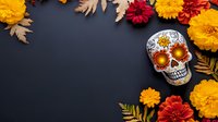 Decorated sugar skull with marigold and red flowers on dark background, Day of Dead celebration border frame with autumn dry leaves and floral arrangement.