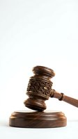 Wooden judge gavel with ornate carved details on sound block against white background for legal and justice concepts.