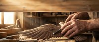 Skilled craftsman hands shaping wood with traditional plane tool in warm sunlit workshop. Artisan woodworking carpentry craftsmanship for furniture making projects.