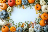 Decorative frame made of colorful autumn pumpkins in orange, white, and blue-gray shades with eucalyptus leaves and fall foliage on white background, copy space in center.