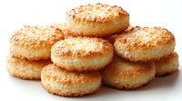 Fresh baked coconut macaroons stacked together showing golden brown crispy exterior and soft interior texture on white background, food photography.