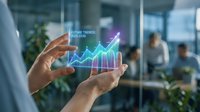 Business professional analyzing holographic growth chart with upward trending arrow in modern office environment showcasing data visualization technology.