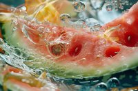 Fresh watermelon slice splashing in clear water with bubbles, creating dynamic motion and refreshing summer feeling.