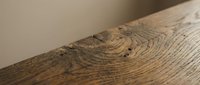 Close-up of natural wood grain texture showing detailed annual rings and organic patterns on timber surface for interior design and carpentry projects.