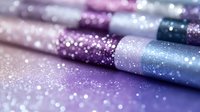 Shimmering makeup brushes with glitter in pastel purple, blue, and pink tones arranged in row, creating dreamy cosmetic flatlay for beauty content.
