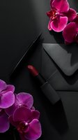 Luxury makeup cosmetics with red lipstick and eyeliner on black background decorated with pink orchid flowers for beauty and fashion concepts.