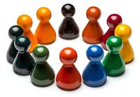 Colorful game pieces arranged in circle formation on white background, showing diversity and teamwork concept. Isolated pawns ready for business presentations.
