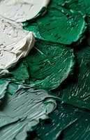 Thick textured strokes of emerald green and white oil paint create dynamic abstract pattern with rich impasto technique showing artistic brushwork detail.