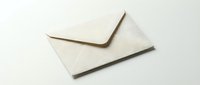 Closed beige textured paper envelope on white background, isolated for design use in correspondence, invitations, and stationery projects.