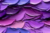 Vibrant purple and pink oil paint strokes create layered texture with thick impasto technique, showing dynamic brushwork movement and artistic expression in macro view.