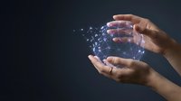 Human hands protecting glowing digital network connections with floating data particles on dark background for technology and cybersecurity concepts.