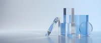 Transparent laboratory glassware and pipette arranged on reflective surface with blue tones, suitable for scientific research, medical testing, pharmaceutical development, and educational content.