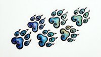 Decorative paw print pendants featuring swirling blue and turquoise enamel designs, isolated on white background, ready for jewelry design, crafts, and product mockups.