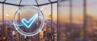 Business success concept with glowing checkmark symbol over blurred city skyline at sunset, representing achievement and corporate validation.