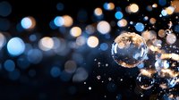 Transparent soap bubbles floating on dark background with blue and orange bokeh lights creating magical atmosphere, macro photography with selective focus.