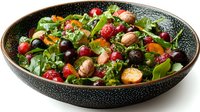 Fresh mixed greens salad with cranberries, nuts and colorful vegetables in rustic bowl for healthy eating and nutrition concepts.
