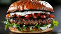 Gourmet beef burger with crispy bacon, melted cheese, fresh lettuce and tomato on toasted artisan bun. Perfect for restaurant menus, food blogs, culinary websites and fast casual dining promotions.