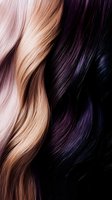 Contrasting blonde and dark purple hair strands in close-up showing smooth, wavy texture and natural shine. For beauty and hair care advertising.