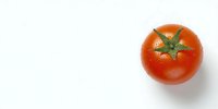 Fresh ripe red tomato with green stem isolated on white background, perfect for food packaging, recipe blogs, and healthy eating concepts.
