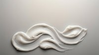 White cream cosmetic texture with smooth flowing waves on neutral background for skincare and beauty product applications.