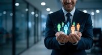 Professional businessman holding glowing human figures representing team management and leadership in modern office environment for corporate presentations.