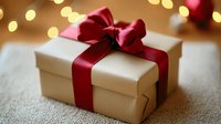 Elegant gift box wrapped in cream paper with luxurious red satin ribbon bow against soft bokeh lights background, creating festive holiday atmosphere.