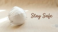 White N95 respirator mask on beige linen surface with Stay Safe text, health protection concept for pandemic awareness and safety campaigns.