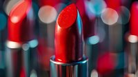 Vibrant red lipstick close-up with blurred cosmetic products in background, showcasing luxury makeup for beauty industry advertising.