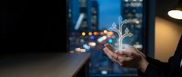 Businessman holding glowing digital tree hologram in modern office with city lights background representing growth, sustainability and eco-friendly business innovation.