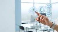 Business professional hand touching digital security icons with cloud and lock symbols in modern office environment for cybersecurity technology solutions.