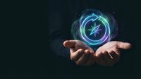 Hand holding glowing neon compass symbol with blue and green light effects against dark background, representing navigation, direction, technology, and digital innovation concepts.